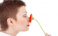 Woman Smelling A Flower