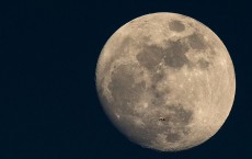 A Plane Is Dwarfed As It Flies Past The Moon