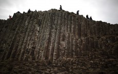 Visitors Enjoy The Ancient Basalt Columns That Form The Giants Causeway