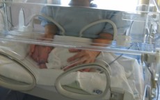 Mother with baby in an incubator