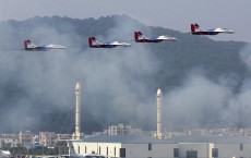 Russian-made Mig-29 fighter jets release flares during an aerobatic performance at the Airshow China in Zhuhai