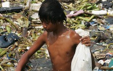 Philippine Kid Picks Plastic Wastes In Seawater Of Manila Bay