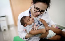 Doctor with Baby Suffering from Microcephaly