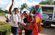 Patient being carried to the hospital by family members, cholera hits Haiti after Hurricane Matthew.