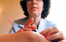 Licensed Practitioner Applies Acupuncture To a Patient's Knee