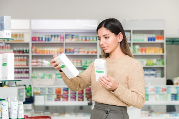 Woman choosing vitamins and siupllements